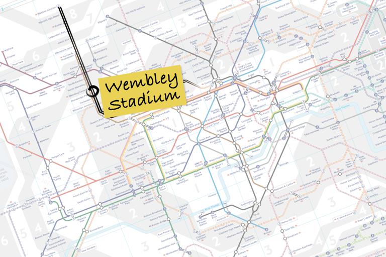 Faded image of the London tube map with the Lioness line marked in black and a post-it with Wembley Stadium written on it